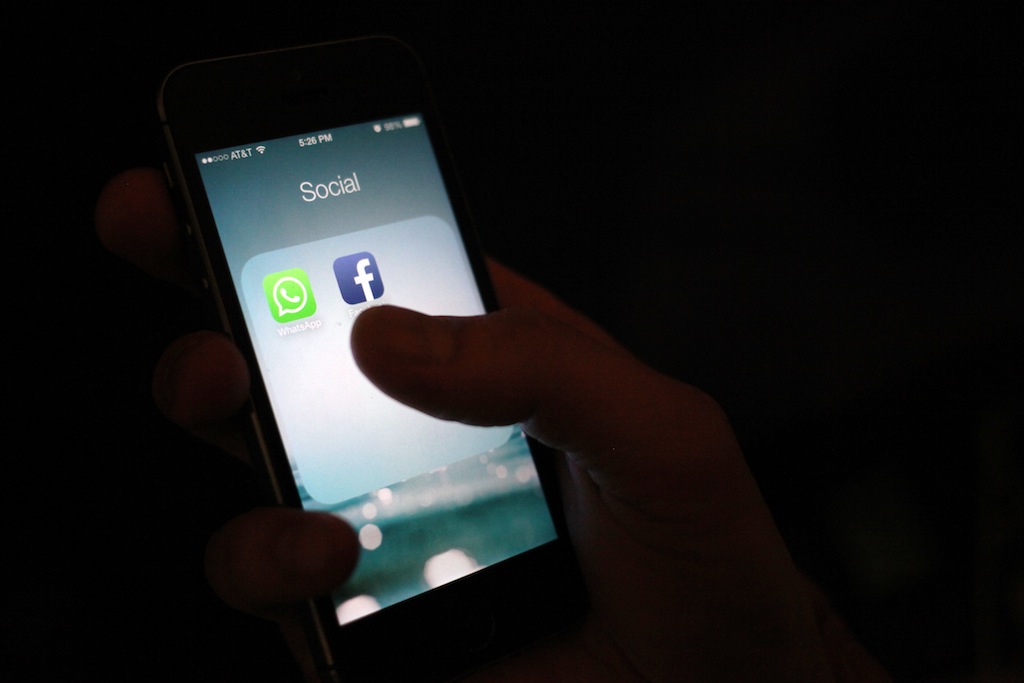 This Wednesday, Feb. 19, 2014 photo, shows the WhatsApp and Facebook app icons on an iPhone in New York. On Wednesday Facebook announced it is buying mobile messaging service WhatsApp for up to $19 billion in cash and stock. (AP Photo/Karly Domb Sadof)